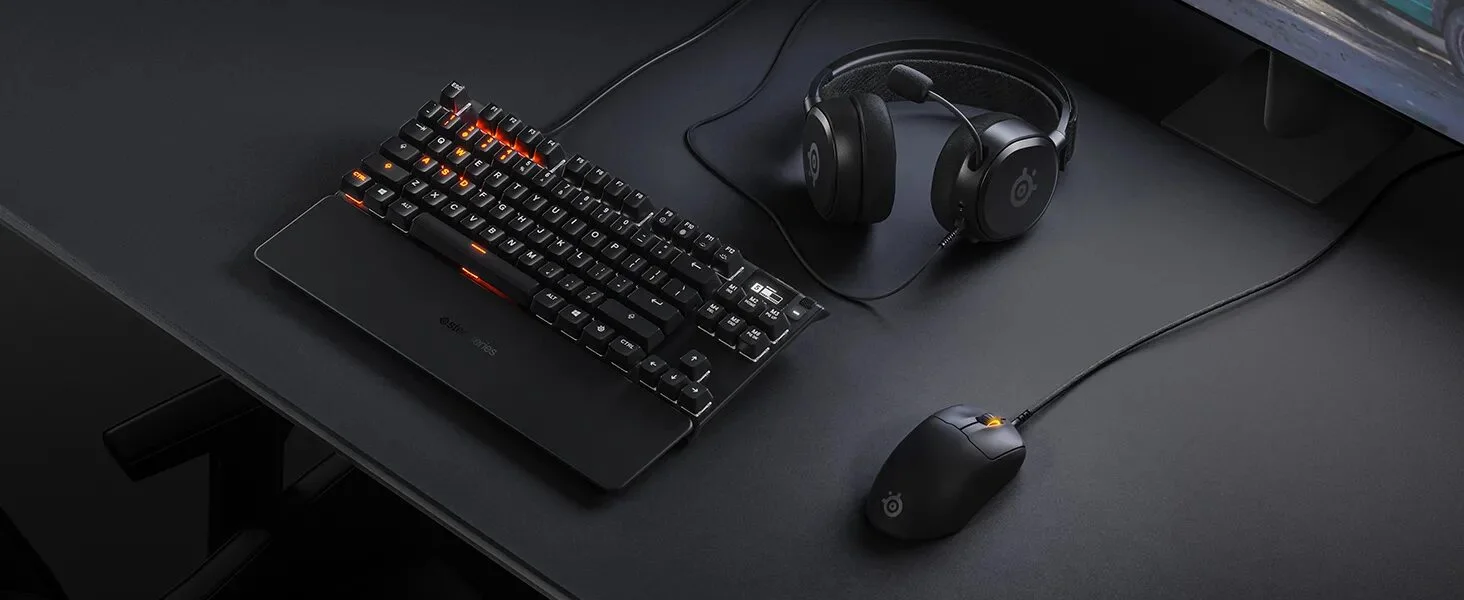 A sleek gaming mouse and mechanical keyboard on a desk.
